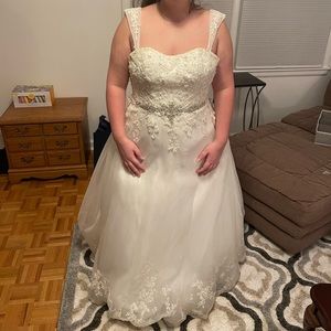 Size 4 wedding dress. Has been altered: taken out, bustles, bra pads added.